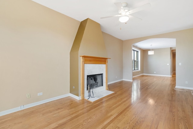 2332 W Huron St Unit 4, Chicago, IL 60612 - unfurnished living room featuring arched walkways, wood finished floors, ceiling fan, and a fireplace