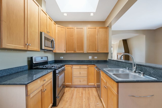 2332 W Huron St Unit 4, Chicago, IL 60612 - kitchen with stainless steel appliances, recessed lighting, light wood-style floors, a peninsula, and a skylight