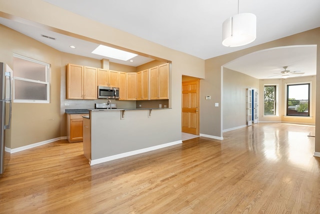 2332 W Huron St Unit 4, Chicago, IL 60612 - kitchen with stainless steel appliances, open floor plan, light brown cabinets, light wood finished floors, and dark countertops