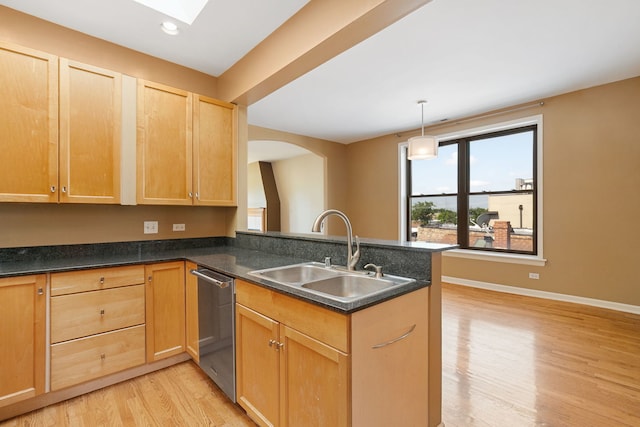 2332 W Huron St Unit 4, Chicago, IL 60612 - kitchen featuring stainless steel dishwasher, a peninsula, light wood-style floors, arched walkways, and light brown cabinetry