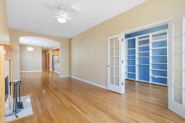 2332 W Huron St Unit 4, Chicago, IL 60612 - unfurnished living room with arched walkways, light wood-type flooring, ceiling fan, and french doors