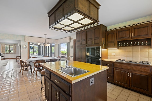 10 Shoreside Dr, South Barrington, IL 60010 - kitchen with black appliances, light tile patterned flooring, healthy amount of natural light, and tasteful backsplash