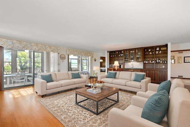 10 Shoreside Dr, South Barrington, IL 60010 - living area with light wood-style flooring and bar