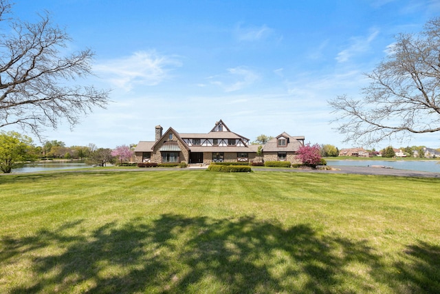 10 Shoreside Dr, South Barrington, IL 60010 - view of front of home with a water view, a front yard, and a chimney
