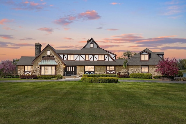 10 Shoreside Dr, South Barrington, IL 60010 - tudor house featuring stone siding, a lawn, and a chimney