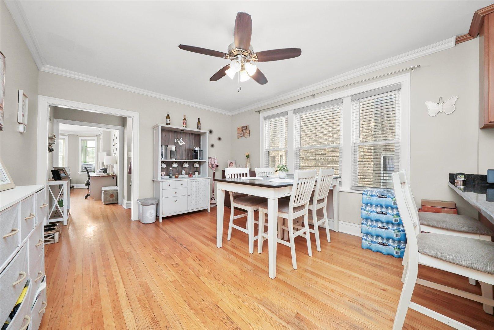 3115 N Marmora Ave, Chicago, IL 60634 - dining area with a ceiling fan, light wood finished floors, and crown molding