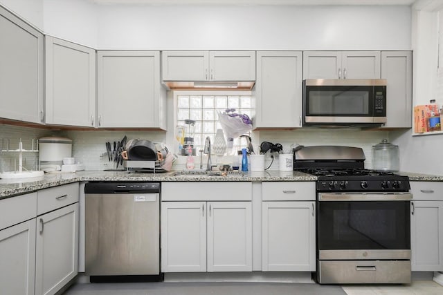 3115 N Marmora Ave, Chicago, IL 60634 - kitchen featuring stainless steel appliances, tasteful backsplash, and light stone countertops