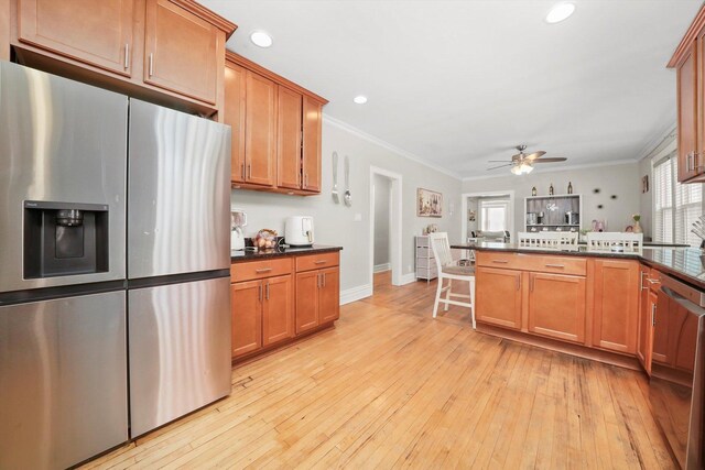 3115 N Marmora Ave, Chicago, IL 60634 - kitchen with appliances with stainless steel finishes, ceiling fan, ornamental molding, a peninsula, and light wood-style flooring