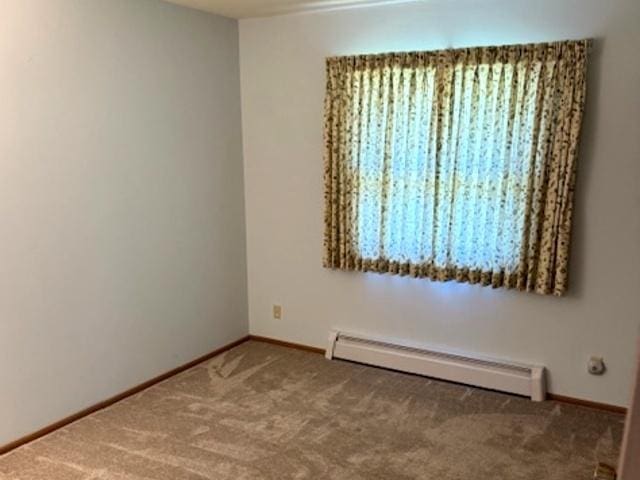12238 Lisbon Rd, Newark, IL 60541 - carpeted empty room with a baseboard radiator and baseboards