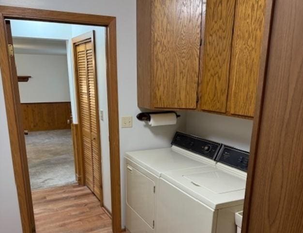 12238 Lisbon Rd, Newark, IL 60541 - laundry room featuring washing machine and dryer, cabinet space, and light wood-type flooring