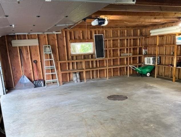 12238 Lisbon Rd, Newark, IL 60541 - garage with wood walls and a garage door opener