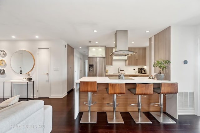3700 Capri Ct Unit 607, Glenview, IL 60025 - kitchen featuring island exhaust hood, modern cabinets, stainless steel fridge, a breakfast bar, and recessed lighting