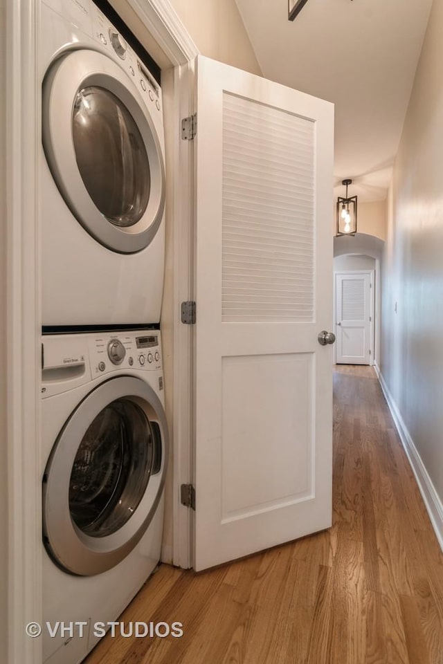 4933 N Winthrop Ave Unit 2S, Chicago, IL 60640 - laundry room featuring stacked washer / dryer and light wood-style flooring