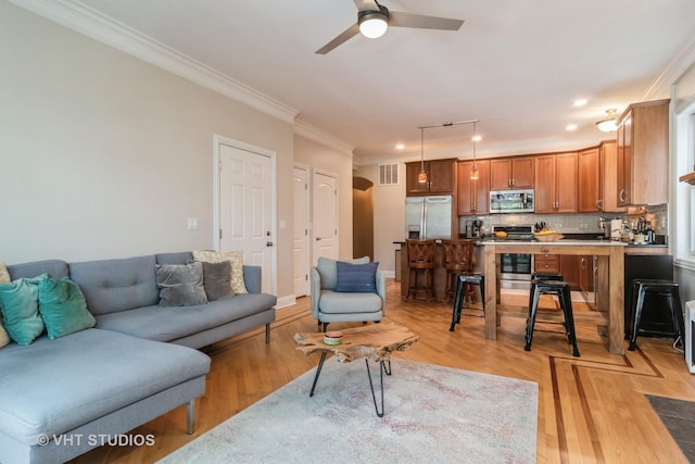 4933 N Winthrop Ave Unit 2S, Chicago, IL 60640 - living area featuring crown molding, arched walkways, a ceiling fan, and light wood-style flooring