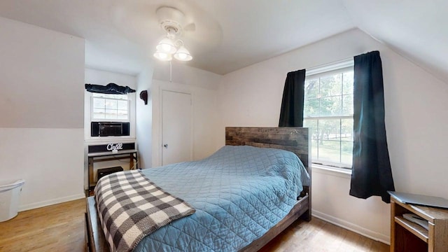 16 W George St, Sullivan, IL 61951 - bedroom featuring multiple windows, wood finished floors, lofted ceiling, and cooling unit