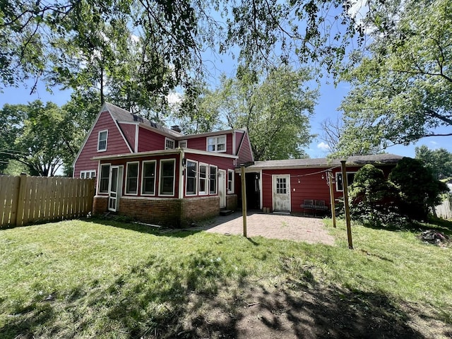 16 W George St, Sullivan, IL 61951 - back of house with a patio, a sunroom, and brick siding