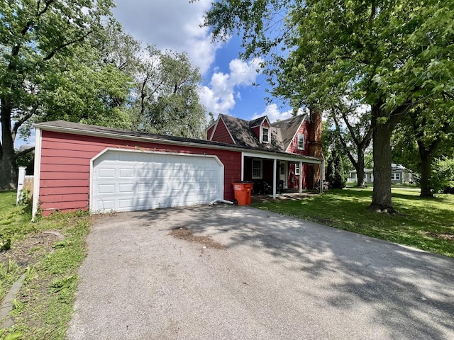 16 W George St, Sullivan, IL 61951 - view of front of property with a front yard, driveway, an attached garage, covered porch, and a chimney