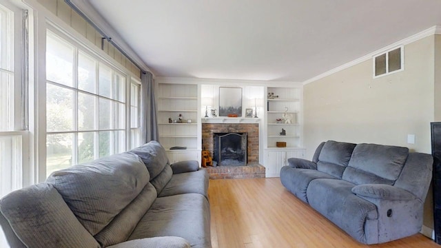 16 W George St, Sullivan, IL 61951 - living area featuring a fireplace, wood finished floors, and crown molding