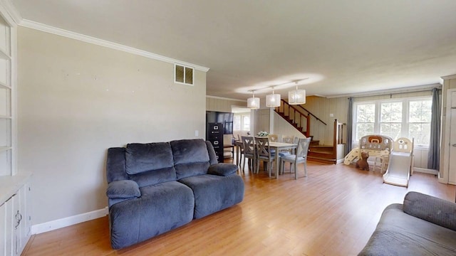 16 W George St, Sullivan, IL 61951 - living room featuring stairs, crown molding, and light wood-type flooring