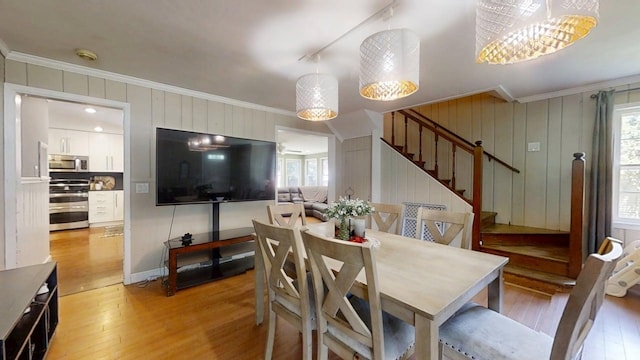 16 W George St, Sullivan, IL 61951 - dining space with crown molding, light wood finished floors, and stairway