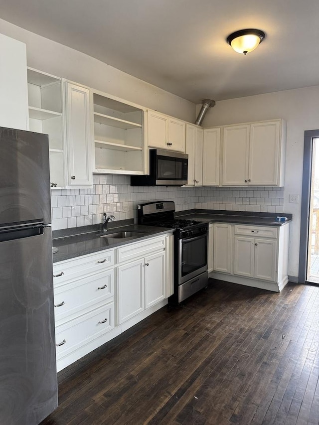 1531 S Kolin Ave, Chicago, IL 60623 - kitchen featuring stainless steel appliances, open shelves, dark countertops, and white cabinets