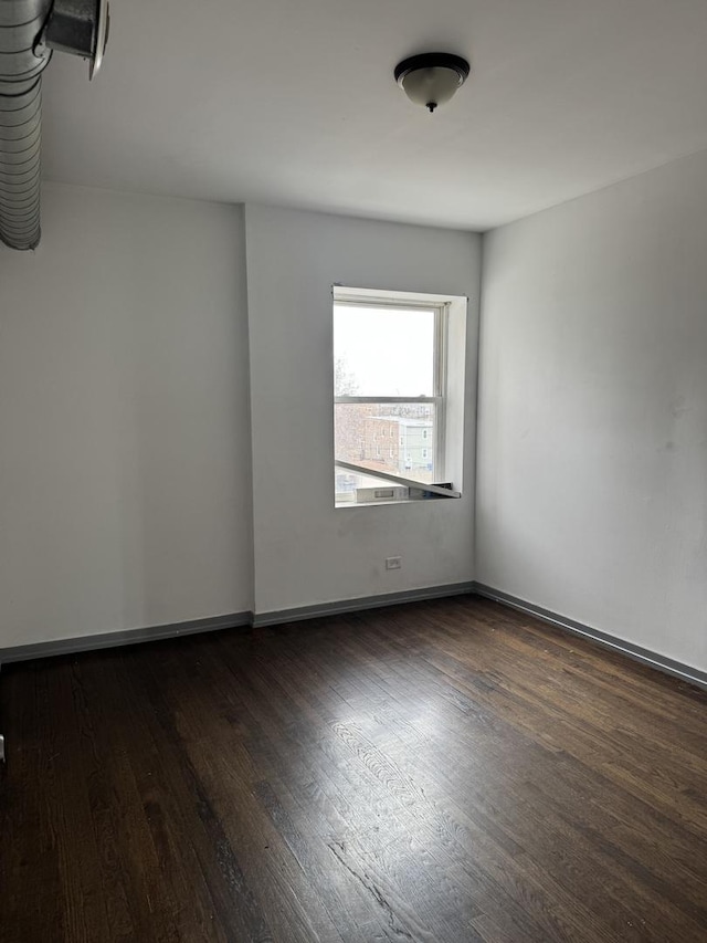 1531 S Kolin Ave, Chicago, IL 60623 - unfurnished room featuring dark wood-type flooring and baseboards