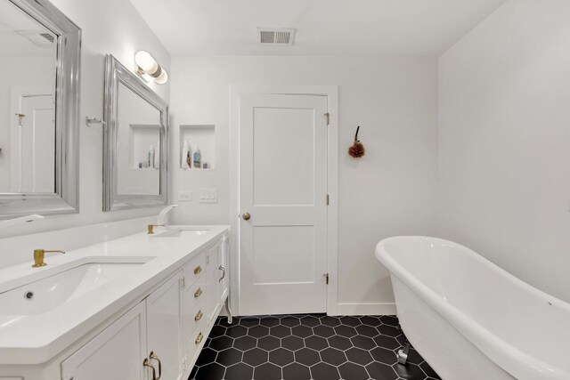 1033 W 14th Pl Unit 337, Chicago, IL 60608 - bathroom featuring a freestanding tub, double vanity, and tile patterned floors