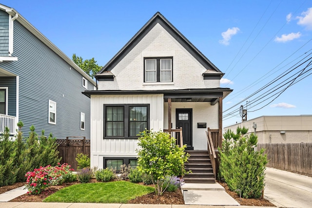 1212 Wesley Ave, Berwyn, IL 60402 - view of front of property featuring covered porch, brick siding, and board and batten siding