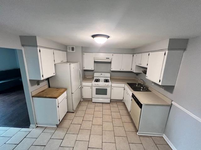11111 S 84th Ave Unit 3A, Palos Hills, IL 60465 - kitchen with white appliances, under cabinet range hood, white cabinets, light tile patterned flooring, and light countertops