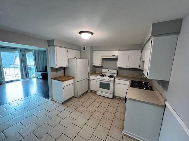11111 S 84th Ave Unit 3A, Palos Hills, IL 60465 - kitchen with white appliances, white cabinetry, light countertops, and light tile patterned flooring