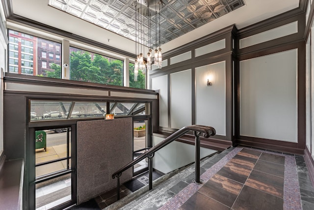 680 S Federal St Unit 409, Chicago, IL 60605 - stairs with an ornate ceiling, a decorative wall, and a chandelier