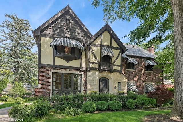 1415 Keystone Ave, River Forest, IL 60305 - tudor house featuring stucco siding, stone siding, brick siding, and a chimney