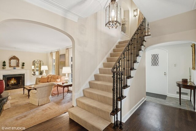 1415 Keystone Ave, River Forest, IL 60305 - stairs featuring arched walkways, wood finished floors, ornamental molding, and a premium fireplace