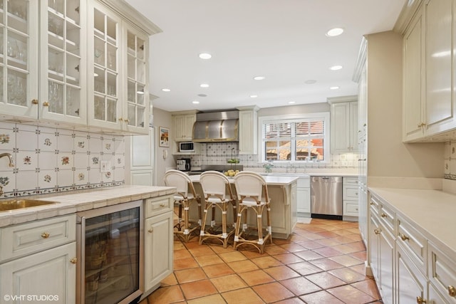 1415 Keystone Ave, River Forest, IL 60305 - kitchen featuring beverage cooler, dishwasher, wall chimney range hood, backsplash, and recessed lighting