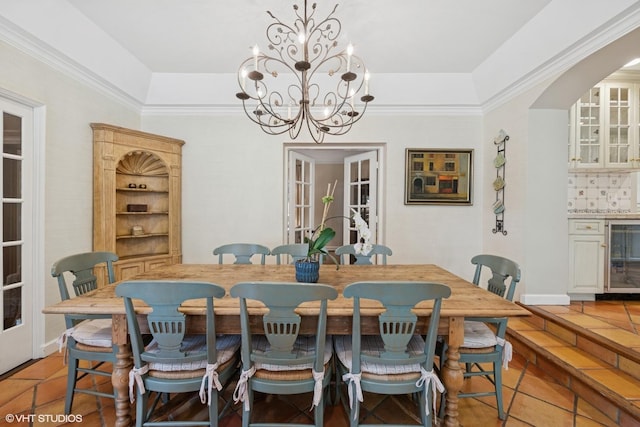 1415 Keystone Ave, River Forest, IL 60305 - dining space with wine cooler, a chandelier, light tile patterned flooring, arched walkways, and a tray ceiling
