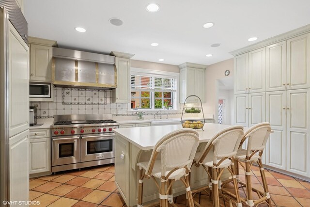 1415 Keystone Ave, River Forest, IL 60305 - kitchen with high end appliances, wall chimney exhaust hood, light countertops, tasteful backsplash, and recessed lighting