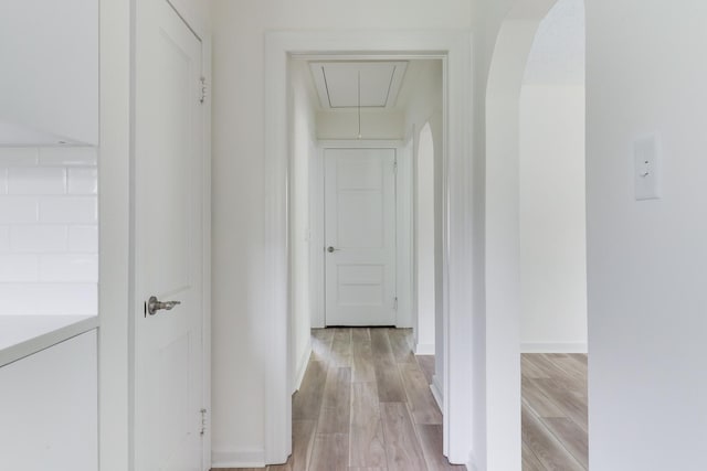 103 S Portland Pl, Clinton, IL 61727 - hall featuring attic access, light wood-type flooring, and arched walkways