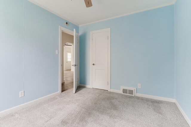 103 S Portland Pl, Clinton, IL 61727 - carpeted empty room with ceiling fan and crown molding