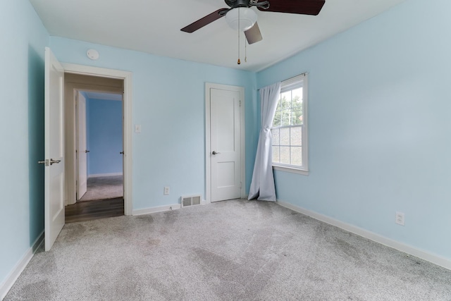 103 S Portland Pl, Clinton, IL 61727 - unfurnished bedroom with carpet flooring and a ceiling fan