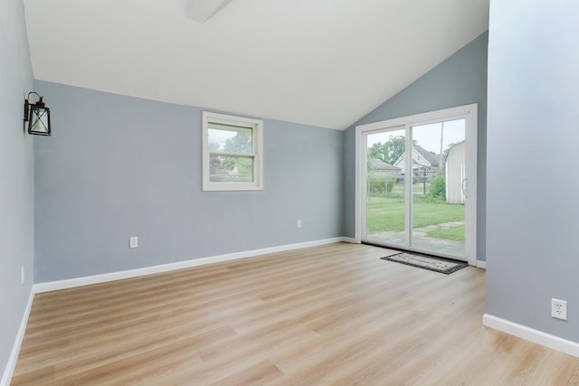 103 S Portland Pl, Clinton, IL 61727 - unfurnished room with lofted ceiling, plenty of natural light, and light wood-style flooring