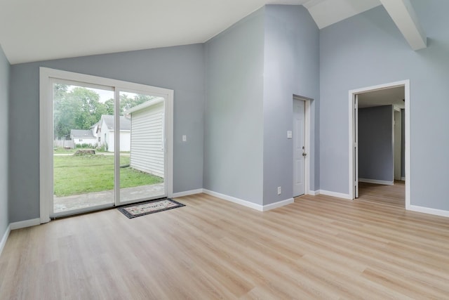 103 S Portland Pl, Clinton, IL 61727 - unfurnished living room with vaulted ceiling and light wood-style flooring