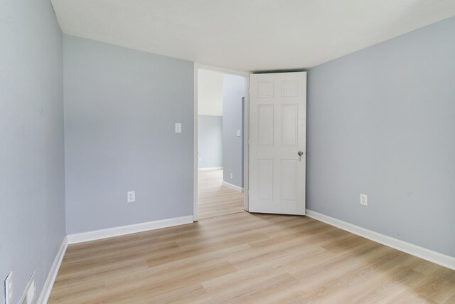 103 S Portland Pl, Clinton, IL 61727 - spare room featuring light wood finished floors and baseboards