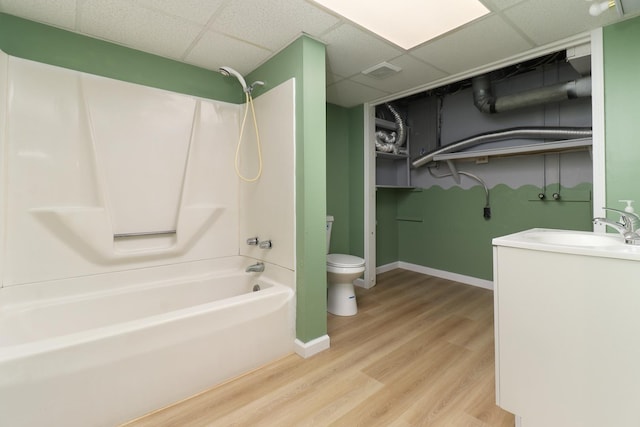 103 S Portland Pl, Clinton, IL 61727 - bathroom with a drop ceiling, bathtub / shower combination, vanity, and wood finished floors