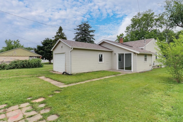 103 S Portland Pl, Clinton, IL 61727 - rear view of house with a lawn, a garage, and a shingled roof