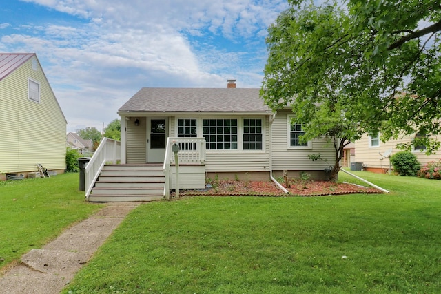 103 S Portland Pl, Clinton, IL 61727 - view of front of home with a front yard, a chimney, and a shingled roof
