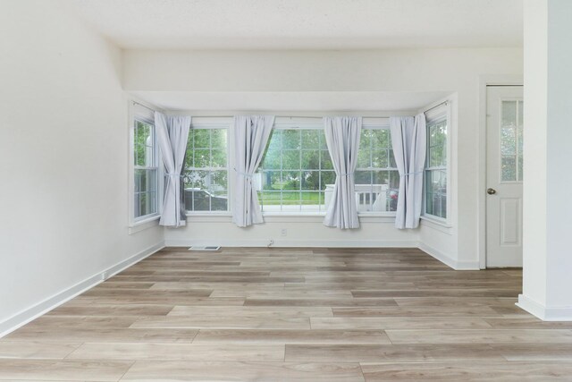 103 S Portland Pl, Clinton, IL 61727 - spare room featuring light wood finished floors and baseboards