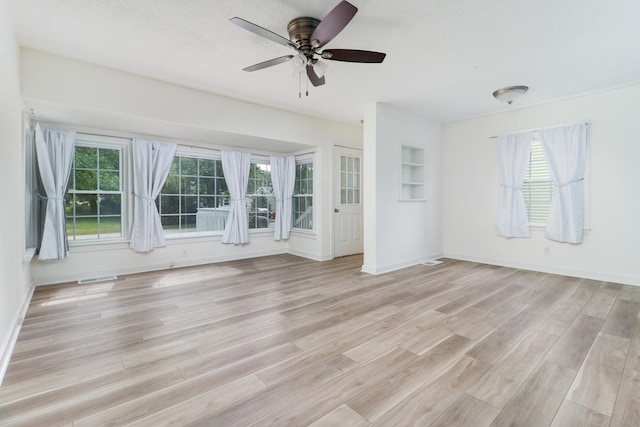 103 S Portland Pl, Clinton, IL 61727 - empty room featuring light wood-style floors and a ceiling fan