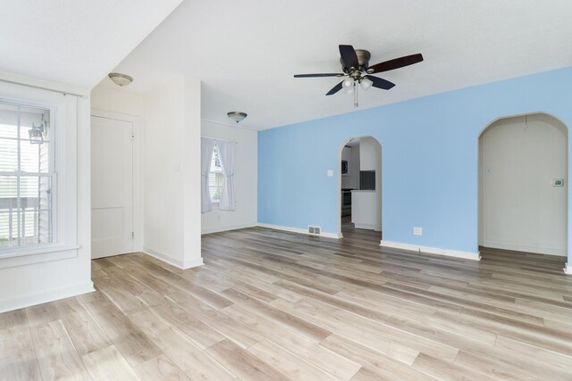 103 S Portland Pl, Clinton, IL 61727 - unfurnished room with arched walkways, a ceiling fan, and light wood-type flooring