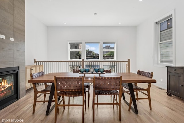 4535 S Evans Ave, Chicago, IL 60653 - dining room with light wood-style flooring, a tile fireplace, and recessed lighting