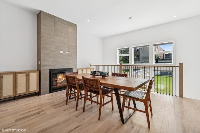 4535 S Evans Ave, Chicago, IL 60653 - dining space with light wood-type flooring, a large fireplace, and recessed lighting